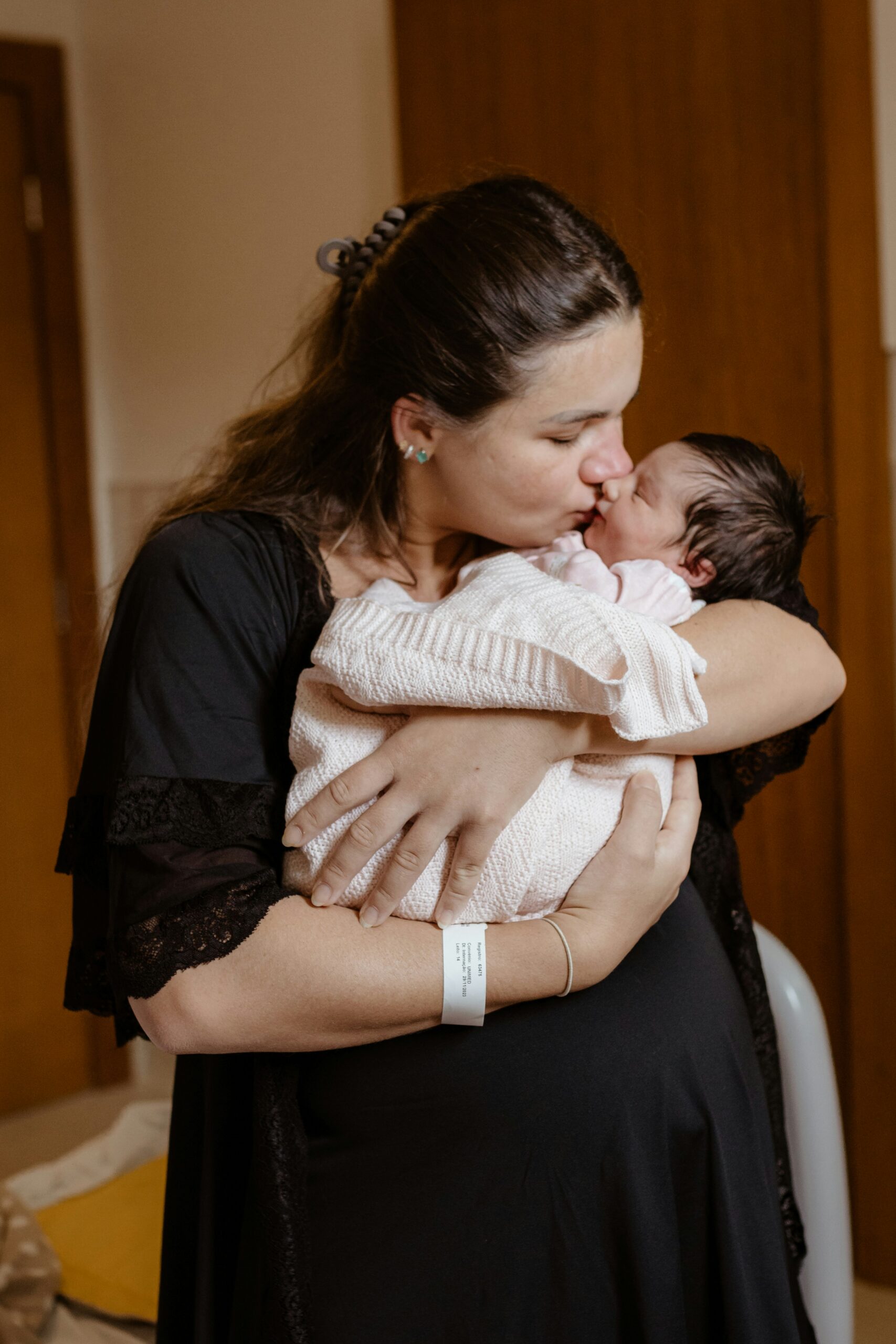 <p>Woman Mother kissing a young baby</p>